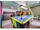 Amusement room with arcade machines, a pool table, and bold decor creating an exciting and playful area at 1427 Fairview Cir, Reunion, FL 34747