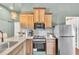 Galley kitchen with granite countertops, stainless steel appliances, and neutral cabinetry at 1427 Fairview Cir, Reunion, FL 34747