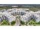 A beautiful aerial view of a resort with fountains, palm trees, and lush landscaping at 14501 Grove Resort Ave # 2522, Winter Garden, FL 34787