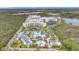 Stunning aerial view of resort featuring a large pool, water slides, and lush landscaping at 14501 Grove Resort Ave # 2522, Winter Garden, FL 34787