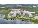 Magnificent aerial view of resort on the lake surrounded by trees and lush landscaping at 14501 Grove Resort Ave # 2522, Winter Garden, FL 34787