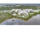 Wonderful aerial of resort featuring a lake, boat dock and lush landscaping at 14501 Grove Resort Ave # 2522, Winter Garden, FL 34787