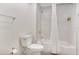 Well-lit bathroom featuring a toilet, and a tub with shower and curtain at 14501 Grove Resort Ave # 2522, Winter Garden, FL 34787