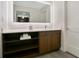 Bathroom vanity featuring a countertop sink, cabinetry, and an illuminated mirror at 14501 Grove Resort Ave # 2522, Winter Garden, FL 34787