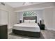 A bedroom with a King-sized bed and a fern print hanging above the headboard at 14501 Grove Resort Ave # 2522, Winter Garden, FL 34787