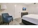 Cozy bedroom featuring a comfortable armchair, TV, dresser, and a neutral color scheme at 14501 Grove Resort Ave # 2522, Winter Garden, FL 34787
