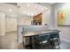 Modern dining area with a booth, wood table, and seating, next to an efficient stainless steel kitchen at 14501 Grove Resort Ave # 2522, Winter Garden, FL 34787
