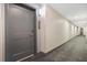 Hallway view with gray door, neutral walls and patterned carpet at 14501 Grove Resort Ave # 2522, Winter Garden, FL 34787