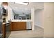 Open-concept kitchen with stainless steel appliances, wooden cabinets, and stylish backsplash at 14501 Grove Resort Ave # 2522, Winter Garden, FL 34787