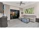 Bright living room featuring a comfortable sofa, modern furnishings, and sliding glass doors at 14501 Grove Resort Ave # 2522, Winter Garden, FL 34787