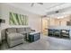 Open-concept living room with a gray sectional sofa, modern decor, and wood flooring at 14501 Grove Resort Ave # 2522, Winter Garden, FL 34787
