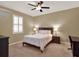 Bedroom featuring a ceiling fan, a window with shutters, and a wood frame bed at 15255 Honeybell Dr, Winter Garden, FL 34787