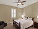 Comfortable bedroom with a ceiling fan, window shutters and a rocking cradle at 15255 Honeybell Dr, Winter Garden, FL 34787