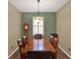 Dining room with a wood table, seating for six, and a unique light fixture at 15255 Honeybell Dr, Winter Garden, FL 34787