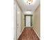 Long hallway with wood floors and neutral wall colors at 15255 Honeybell Dr, Winter Garden, FL 34787