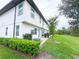 Exterior view of a home featuring a grassy backyard and maintained hedges at 1549 Discovery St, Davenport, FL 33896