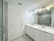 Contemporary bathroom featuring dual sinks, white cabinets, tile flooring and glass shower doors at 1549 Discovery St, Davenport, FL 33896