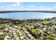 An aerial view of a residential area with lovely homes near a tranquil lake at 1562 Auburn Oaks Ct, Auburndale, FL 33823