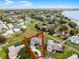 Aerial image shows a home's relationship to adjacent properties, street access, and lake at 1562 Auburn Oaks Ct, Auburndale, FL 33823