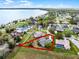 A home's approximate property lines in relation to adjacent properties and a picturesque lake at 1562 Auburn Oaks Ct, Auburndale, FL 33823