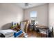 Bedroom featuring hard wood floors, ceiling fan, window with blind and multiple moving boxes throughout at 1562 Auburn Oaks Ct, Auburndale, FL 33823