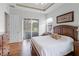 Beautiful bedroom featuring lots of natural light, wood floors, and comfortable decor at 1562 Auburn Oaks Ct, Auburndale, FL 33823