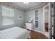 Bedroom with light-blue walls, colorful decor, hardwood floors, and lots of natural light at 1562 Auburn Oaks Ct, Auburndale, FL 33823