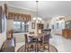 Cozy dining area with a round table and chairs, adjacent to the entryway at 1562 Auburn Oaks Ct, Auburndale, FL 33823