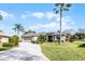 Beautifully landscaped home with a large driveway and mature palm trees for an authentic Florida feel at 1562 Auburn Oaks Ct, Auburndale, FL 33823