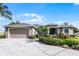 Charming single-story home featuring a two-car garage and lush landscaping at 1562 Auburn Oaks Ct, Auburndale, FL 33823