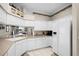 Clean kitchen showcasing white cabinetry, a refrigerator, and a corner sink at 1562 Auburn Oaks Ct, Auburndale, FL 33823