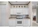 Functional kitchen area with white appliances, cabinets, and a neutral countertop at 1562 Auburn Oaks Ct, Auburndale, FL 33823