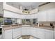 Bright kitchen with white cabinets, neutral countertops, and modern appliances at 1562 Auburn Oaks Ct, Auburndale, FL 33823