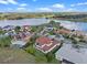 Beautiful aerial view of a lakeside community highlighting a home with a tile roof and manicured lawn at 15644 Panther Lake Dr, Winter Garden, FL 34787