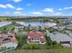 Stunning aerial view of an estate home overlooking a serene lake and lush landscaping at 15644 Panther Lake Dr, Winter Garden, FL 34787