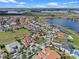 Breathtaking aerial shot of a community nestled near a tranquil lake, showcasing luxurious homes at 15644 Panther Lake Dr, Winter Garden, FL 34787