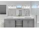 Bright bathroom with double sinks, modern fixtures, and a large mirror at 15644 Panther Lake Dr, Winter Garden, FL 34787