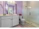 Well-lit bathroom features a glass shower with white tile and a white vanity with quartz countertop at 15644 Panther Lake Dr, Winter Garden, FL 34787