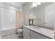 Bathroom with tub-shower combo, white tile surround, and a single sink vanity at 15644 Panther Lake Dr, Winter Garden, FL 34787