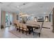 Bright dining room featuring a dark wood table, beige chairs and a decorative light fixture at 15644 Panther Lake Dr, Winter Garden, FL 34787