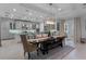 Open dining area with a large dark wood table with bench seating and access to the modern kitchen at 15644 Panther Lake Dr, Winter Garden, FL 34787