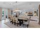 Bright dining room featuring a dark wood table, beige chairs and a decorative light fixture at 15644 Panther Lake Dr, Winter Garden, FL 34787