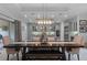 An open dining area with a large dark wood table with a bench that leads to a modern kitchen at 15644 Panther Lake Dr, Winter Garden, FL 34787