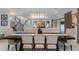 Bright dining room with dark wood table, beige chairs, and decorative light fixture at 15644 Panther Lake Dr, Winter Garden, FL 34787