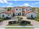 Stunning two-story home with a brick driveway, red tile roof, and elegant landscaping at 15644 Panther Lake Dr, Winter Garden, FL 34787