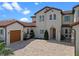 Beautiful home featuring a brick driveway, a charming arched doorway, and a private gate at 15644 Panther Lake Dr, Winter Garden, FL 34787