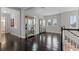 Hallway with hardwood floors, arched windows, and glass cabinets at 15644 Panther Lake Dr, Winter Garden, FL 34787