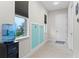 Mudroom featuring built-in storage with hooks, a window, and access to the garage at 15644 Panther Lake Dr, Winter Garden, FL 34787