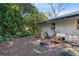 Backyard with a fire pit and wooden chairs, surrounded by lush greenery, offering a serene outdoor space at 1575 Belfast Ct, Apopka, FL 32712