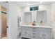 Bathroom featuring a double vanity with modern sinks, tiled floors, and large mirrors at 1575 Belfast Ct, Apopka, FL 32712